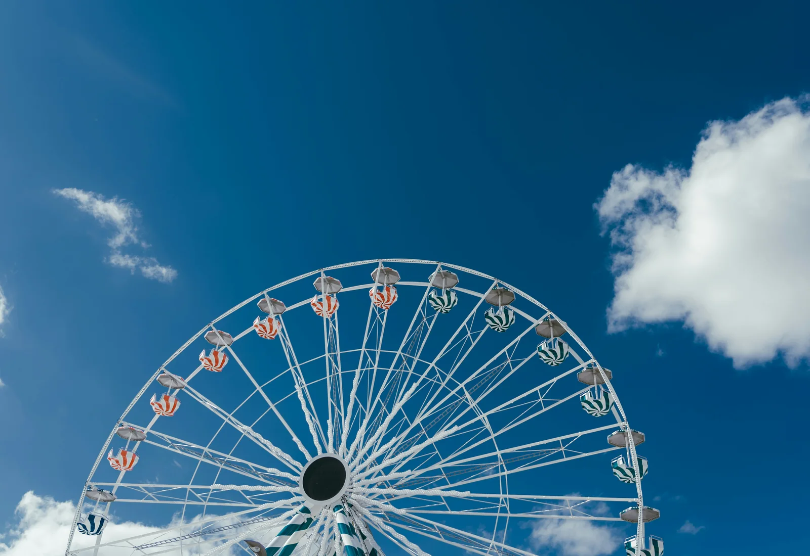 A large Ferris wheel photographed from below against a blue sky, representative of the Wiener Riesenrad in the Prater